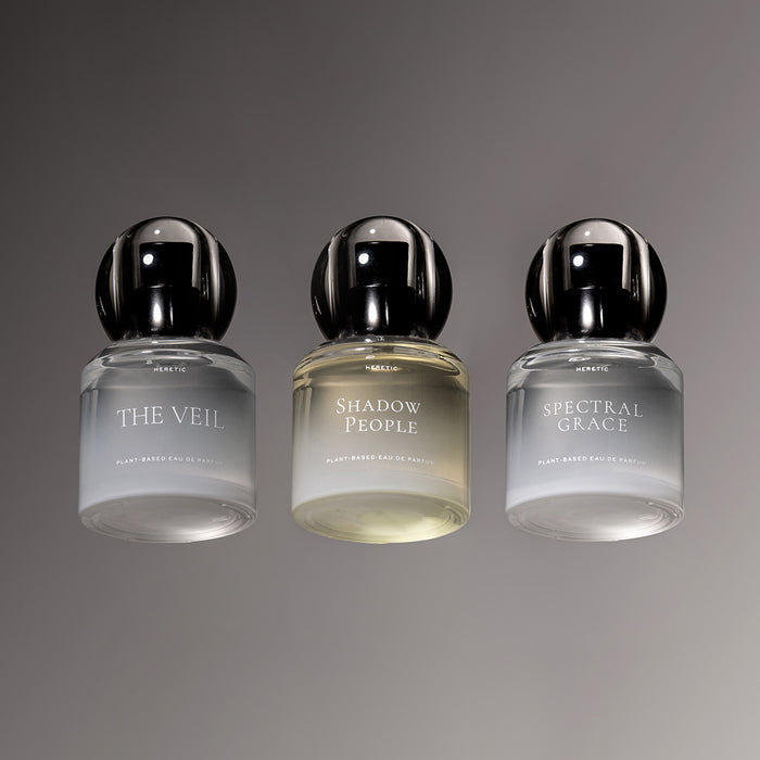 Three perfume bottles labeled 'The Veil', 'Shadow People', and 'Spectral Grace' on a gray background.