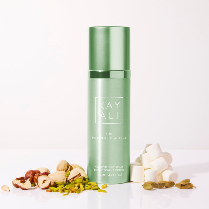 Green bottle with 'KAYALI' branding on a white background with decorative elements.